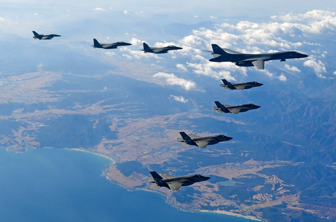 A US Air Force B-1B bomber along with South Korean and US fighter jets fly over the Korean Peninsula during the Vigilant air combat exercise on December 6, 2017.