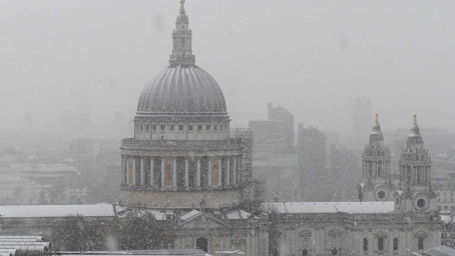 Snow falls on St. Paul's Cathedral in central London on Sunday.
