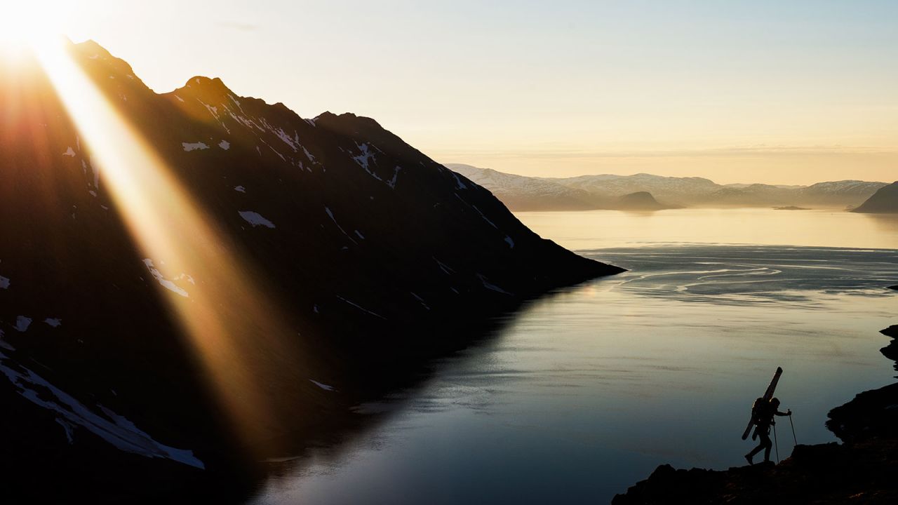 Chad Sayers hiking up from the fjord on a late night ski touring mission on Stjernøya, Norway.