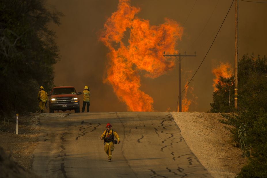 Flames rise as a fire approaches the Lake Casitas area of Ojai on December 8.