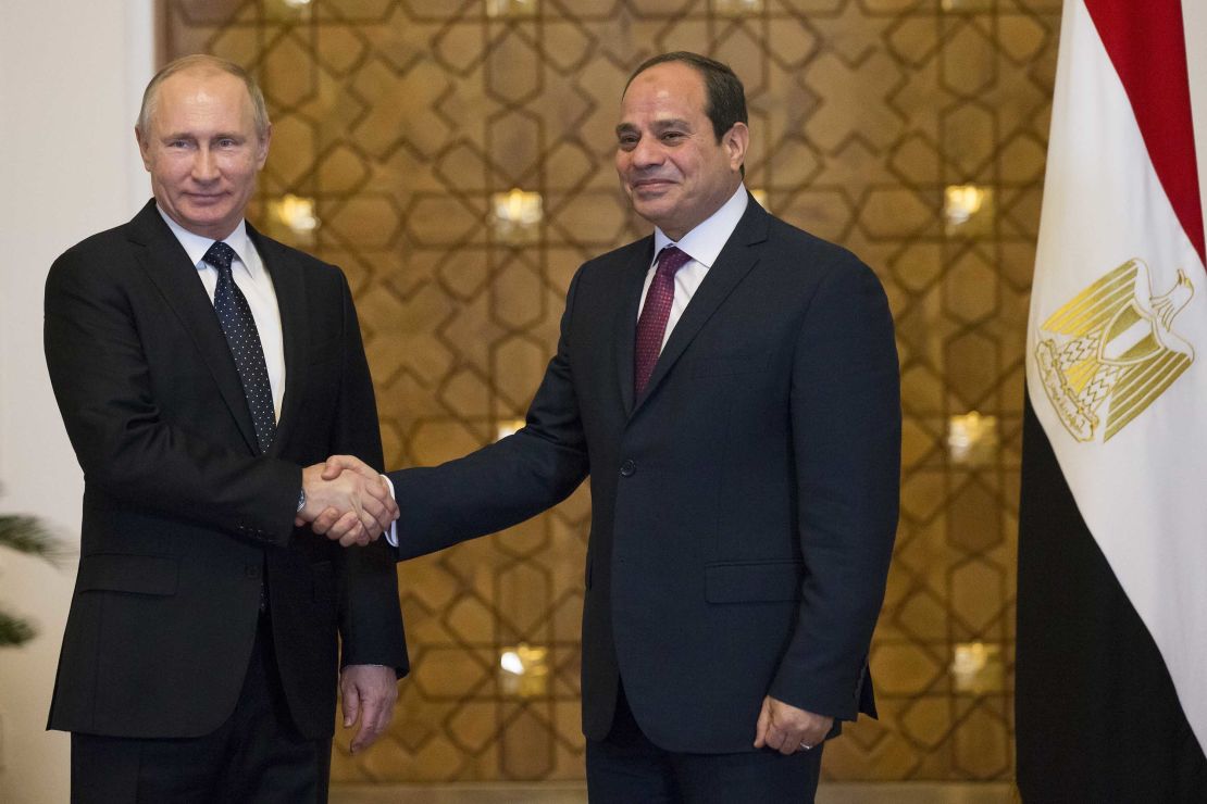 Putin (L) and Sisi shake hands during their meeting in Cairo on Monday.