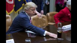 US President Donald J. Trump moves a drink across the table prior to participating in a health care discussion with House Energy and Commerce Chairman Greg Walden (R) and House Ways and Means Committee Chairman Kevin Brady (L) in the Roosevelt Room of the White House in Washington, DC , USA, 10 March 2017.  