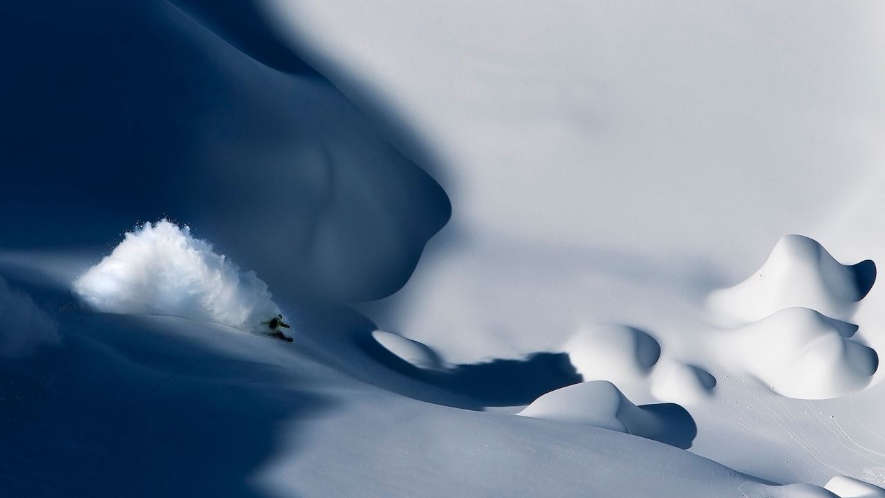 <strong>Shadow surfing:</strong> "This is one of my favorite pictures. I'd been looking for this to line up for six years. I saw the shadow and asked snowboarder Yves Husler to hit it. He jumped into the turn and made a huge cloud. We had one chance and we had to try to nail it. I like the deep blue shadows and the contrasts with light and shade. This probably defines my style and is what I'm looking for in a graphic, beautiful image." -- <em>Oskar Enander.</em><br />