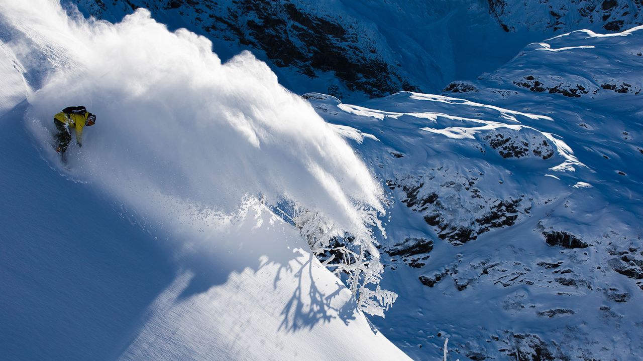 Snowboarder Yves Husler rides a white wave in Engelberg, Switzerland.