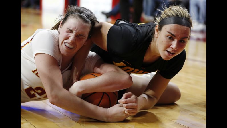 Iowa State's Bridget Carleton, left, scrambles for a loose ball with Iowa's Hannah Stewart during a college basketball game on Wednesday, December 6.