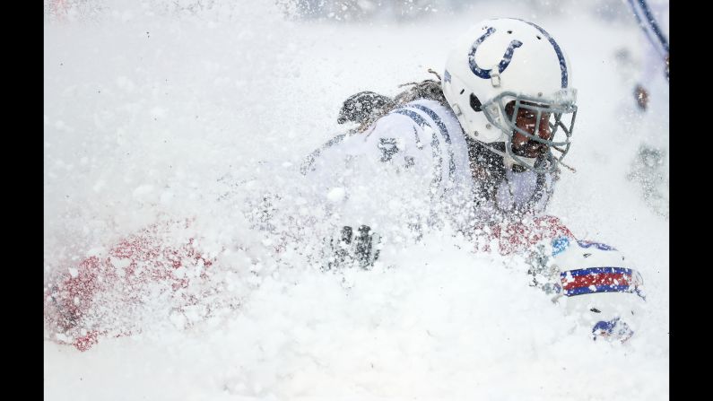 Indianapolis safety Matthias Farley tackles Buffalo tight end Charles Clay during a snowy NFL game in Orchard Park, New York, on Sunday, December 10.