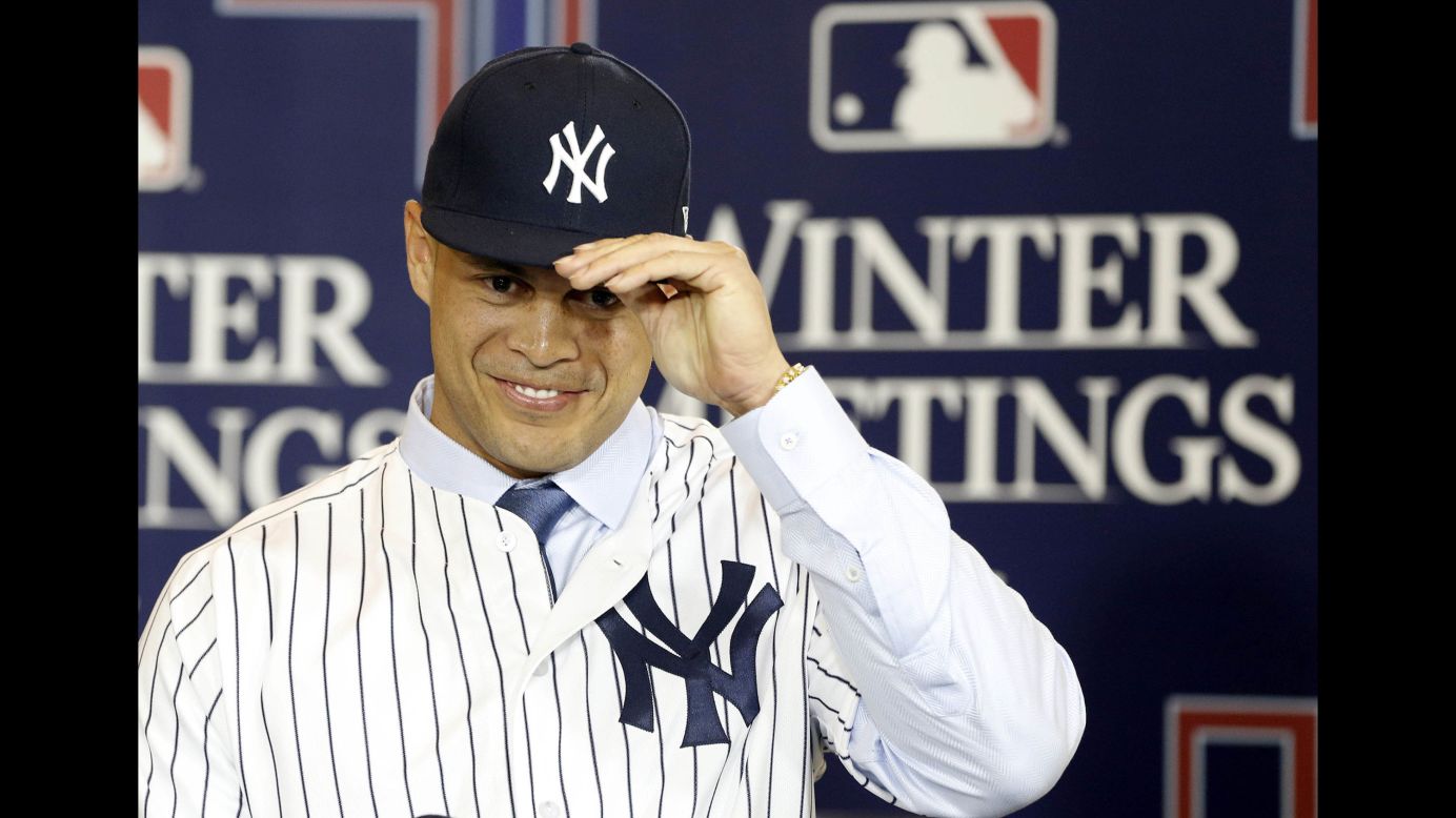 Giancarlo Stanton adjusts his cap as he is presented as the newest member of the New York Yankees on Monday, December 11. Stanton, the National League MVP who hit 59 home runs this past season, <a href="http://bleacherreport.com/articles/2748746-report-marlins-threatened-giancarlo-stanton-to-accept-giants-cardinals-trade" target="_blank" target="_blank">was traded to the Yankees from Miami. </a>The Marlins received second baseman Starlin Castro and two minor-league prospects, Jorge Guzman and Jose Devers.