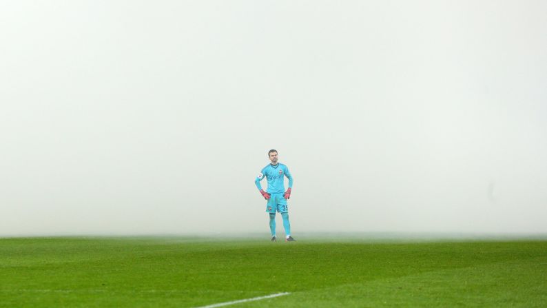 Smoke surrounds CSKA Moscow goalkeeper Igor Akinfeev during a Russian league match against Spartak Moscow on Sunday, December 10. The smoke came from flares that fans had lit.