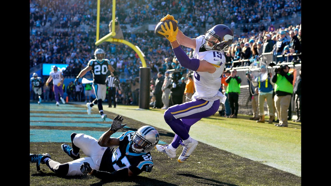 Minnesota wide receiver Adam Thielen tries to pull in a pass during an NFL game in Charlotte, North Carolina, on Sunday, December 10. It was initially ruled a touchdown catch, but it was overturned after a replay showed Thielen bobbling the ball as he went out of bounds.