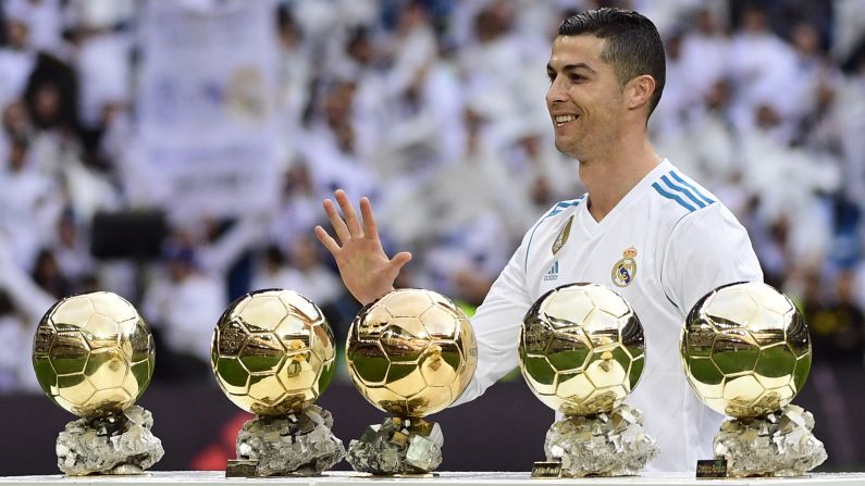Real Madrid star Cristiano Ronaldo poses with his <a href="index.php?page=&url=http%3A%2F%2Fwww.cnn.com%2F2017%2F12%2F08%2Ffootball%2Fcristiano-ronaldo-ballon-dor-lionel-messi-social-media%2Findex.html" target="_blank">five Ballon d'Or trophies</a> before a Spanish league match against Sevilla on Saturday, December 9. Ronaldo now shares the record with Barcelona's Lionel Messi.