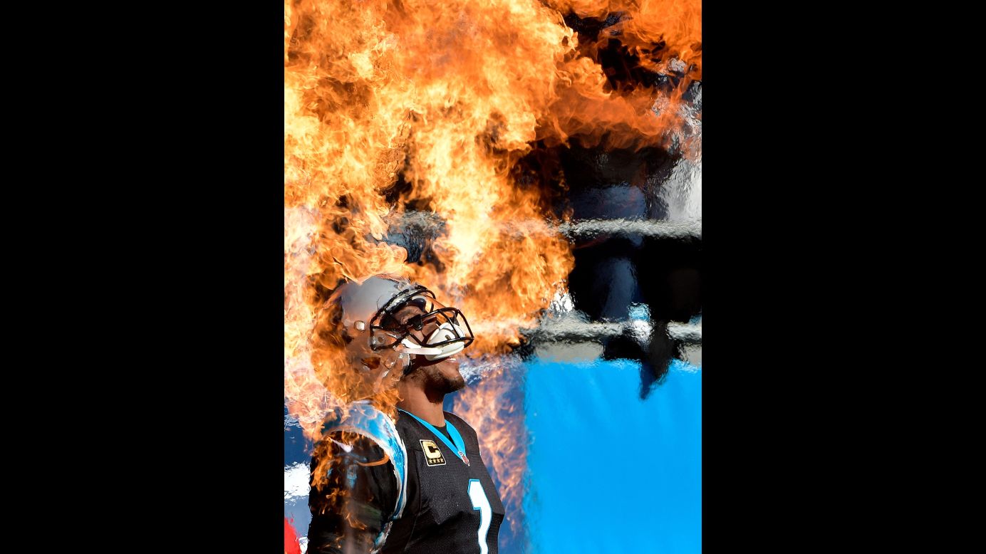 Carolina quarterback Cam Newton walks through pyrotechnics before an NFL game in Charlotte, North Carolina, on Sunday, December 10.