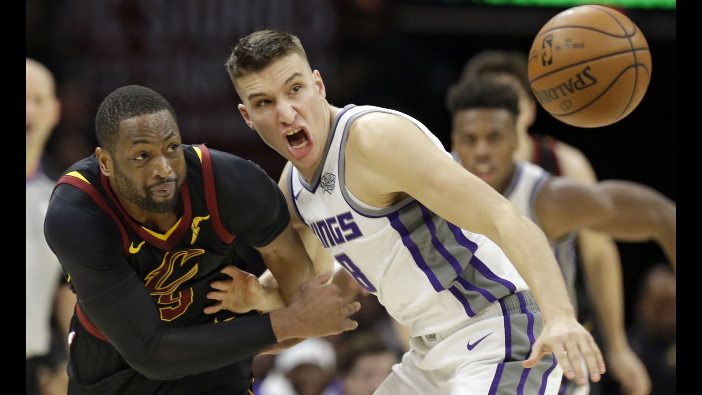 Cleveland's Dwyane Wade, left, and Sacramento's Bogdan Bogdanovic eye a loose ball during an NBA game in Cleveland on Wednesday, December 6.