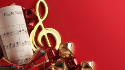 Several Christmas bells and red ribbon on the sheet music from the Christmas classic  Jingle Bells.To see more holiday images click on the link below: