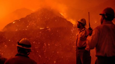 Firefighters monitor the Thomas fire as it burns through Los Padres National Forest.