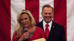 Republican Senatorial candidate Roy Moore smiles as his wife Kayla speaks at a rally in Midland, Alabama, on December 11, 2017. / AFP PHOTO / JIM WATSON        (Photo credit should read JIM WATSON/AFP/Getty Images)