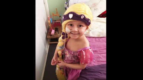 Five-year-old Sophie is battling acute lymphoblastic leukemia. She received a long Rapunzel wig from the Magic Yarn Project and loves wearing it with her Rapunzel dress. 