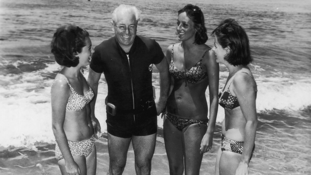 Australian prime minister Harold Holt on the beach with his three daughters-in-law, circa 1966.