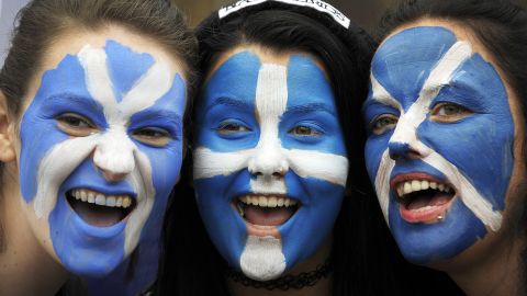 Pro Independence supporters pose with their faces painted with St Andrew's Cross during a rally in George Square in Glasgow, Scotland, on September 19, 2015. 