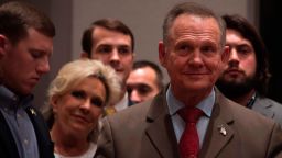Republican Senatorial candidate Roy Moore (R) stands off stage with his wife Kayla (2nd L) before addressing his supporters in Montgomery, Alabama, on December 12, 2017.
Democrat Doug Jones scored a victory Tuesday in a fiercely contested US Senate race in conservative Alabama, dealing a setback to US President Donald Trump, whose candidate could not overcome damaging sexual misconduct accusations. With 92 percent of precincts reporting, former prosecutor Jones secured 49.5 percent of the vote compared to Roy Moore's 48.8 percent, CNN and other networks reported.
 / AFP PHOTO / JIM WATSON        (Photo credit should read JIM WATSON/AFP/Getty Images)