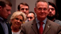 Republican Senatorial candidate Roy Moore stands off stage with his wife Kayla, second from left, before addressing his supporters in Montgomery, Alabama, on December 12, 2017.