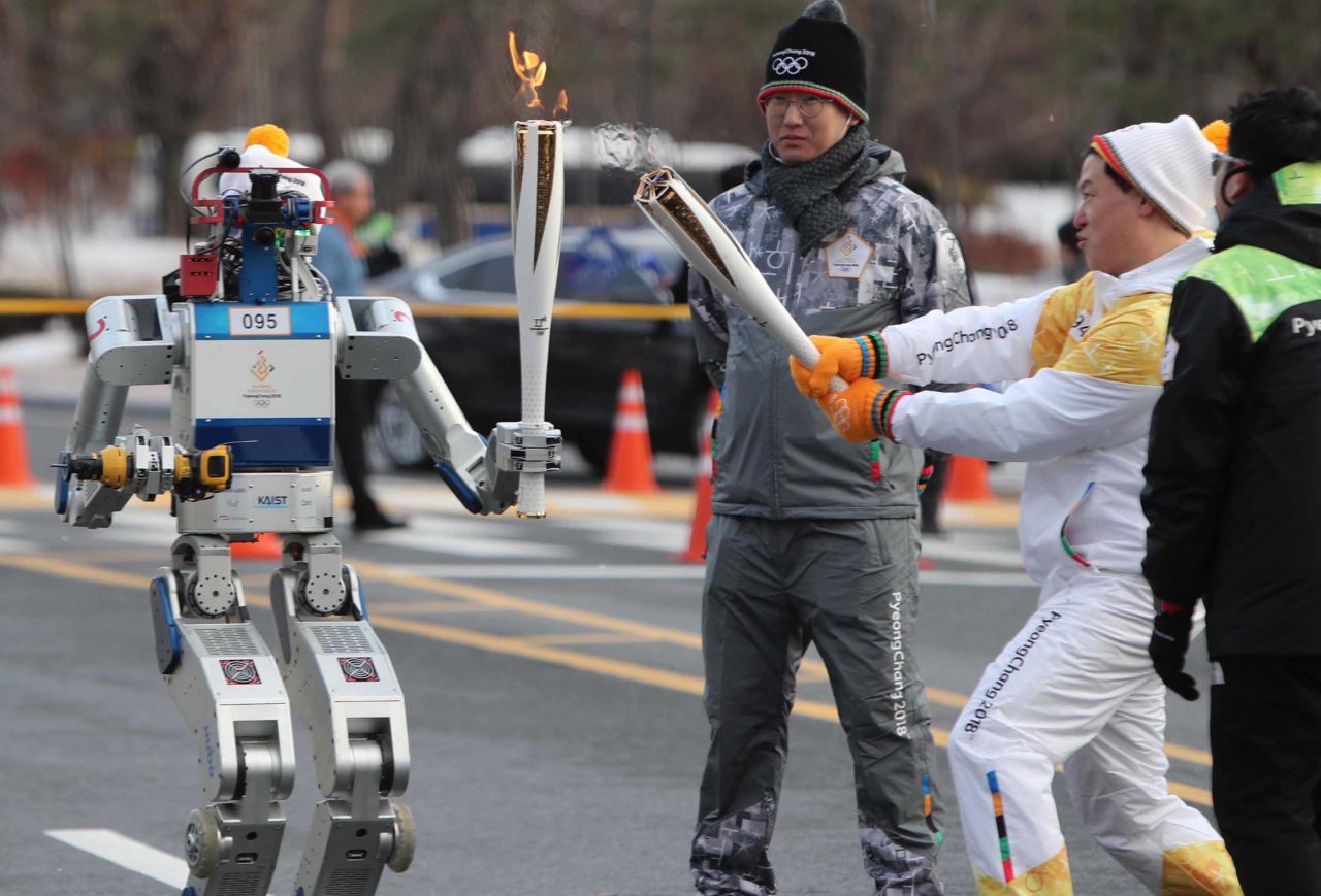 While the Olympics have traditionally been the realm of human competition, it appears robots are coming for next year's Games in South Korea. A humanoid bot, dubbed HUBO, received the iconic flame from Dr Dennis Hong in Daejeon on Monday 11 December 2017.
