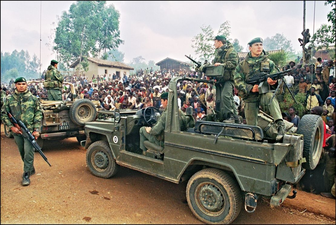 Hutus welcoming a French marines detachment as they drive through a refugee camp, some 4kms outside Butare, in July 1994. 