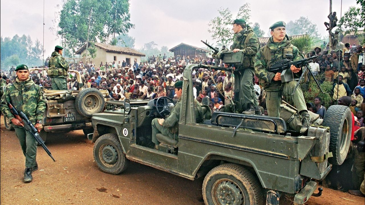 Hutus welcoming a French marines detachment as they drive through a refugee camp, some 4kms outside Butare, in July 1994. 