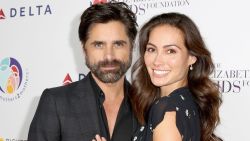 BEVERLY HILLS, CA - OCTOBER 24:  (EDITORIAL USE ONLY. NO COMMERCIAL USE)  John Stamos (L) and Caitlin McHugh attend The Elizabeth Taylor AIDS Foundation and mothers2mothers dinner at Ron Burkle's Green Acres Estate on October 24, 2017 in Beverly Hills, California.  (Photo by Rachel Murray/Getty Images for mothers2mothers and The Elizabeth Taylor AIDS Foundation )
