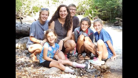 Avery Reilly, 10, bottom left, can't walk or talk because of a rare condition. But her family has helped her lead a fulfilling life. Every year, the Reilly family -- from left, Trinity, Avery, Helena, Brennan, Emory and Presley -- vacations near Cement Creek, Colorado. Avery loves to throw rocks in the water. 