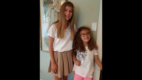 Avery and her sister Presley took a first-day-of-school photo in August 2016. Presley helped Avery stand up by leaning her against the wall.  "Avery loves school and was so excited to be heading back to school after her August break," her father said.