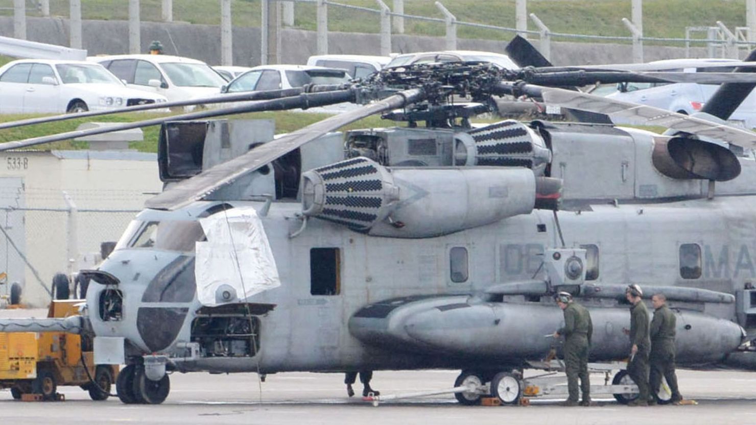 A US military CH-53E transport helicopter, with one of the windows (left) covered, is parked at the US Marine Corps Air Station Futenma in Ginowan, Okinawa, on December 13.