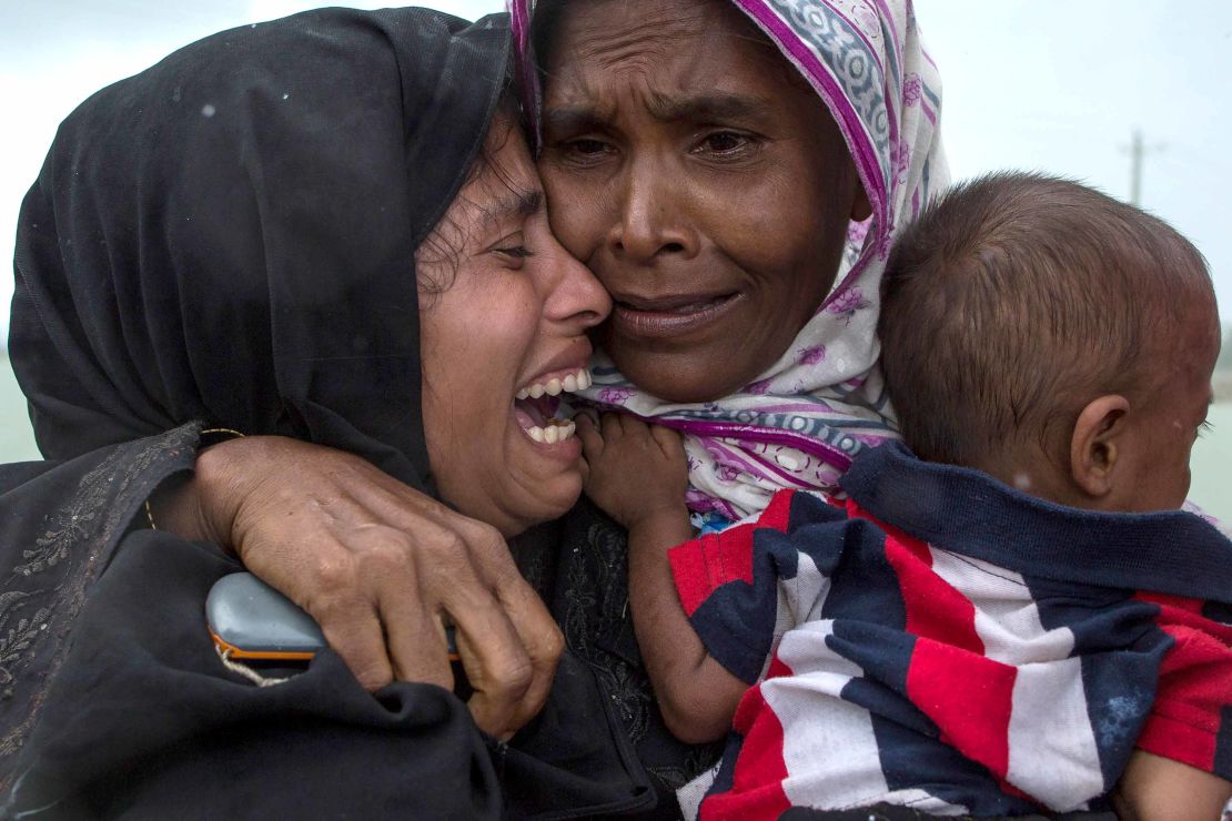 Rohingya Muslim refugees react after being re-united with each other after arriving on a boat from Myanmar on September 08, 2017 in Whaikhyang Bangladesh. 