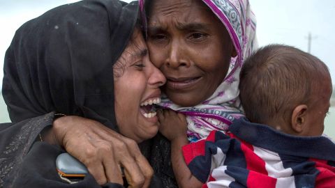 Rohingya Muslim refugees react after being re-united with each other after arriving on a boat from Myanmar on September 08, 2017 in Whaikhyang Bangladesh. 