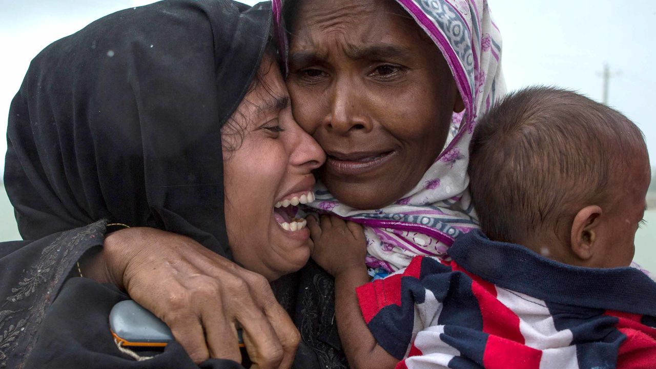 Rohingya Muslim refugees react after being re-united with each other after arriving on a boat from Myanmar on September 08, 2017 in Whaikhyang Bangladesh. 