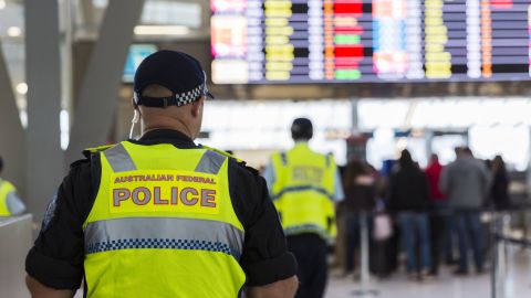 Police guard the passenger security check area at Sydney Airport on July 30.