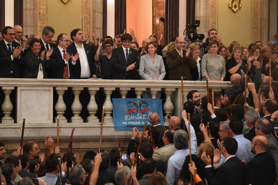Carles Puigdemont, center on balcomy, addresses Catalan mayors after parliament voted in favor of independence on October 27, 2017.