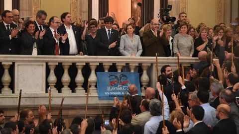 Carles Puigdemont, center on balcomy, addresses Catalan mayors after parliament voted in favor of independence on October 27, 2017.