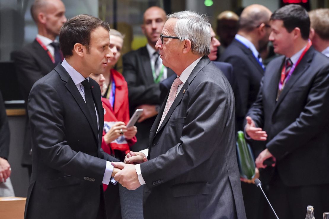 France's Emmanuel Macron speaks with European Commission President Jean-Claude Juncker on Thursday. 