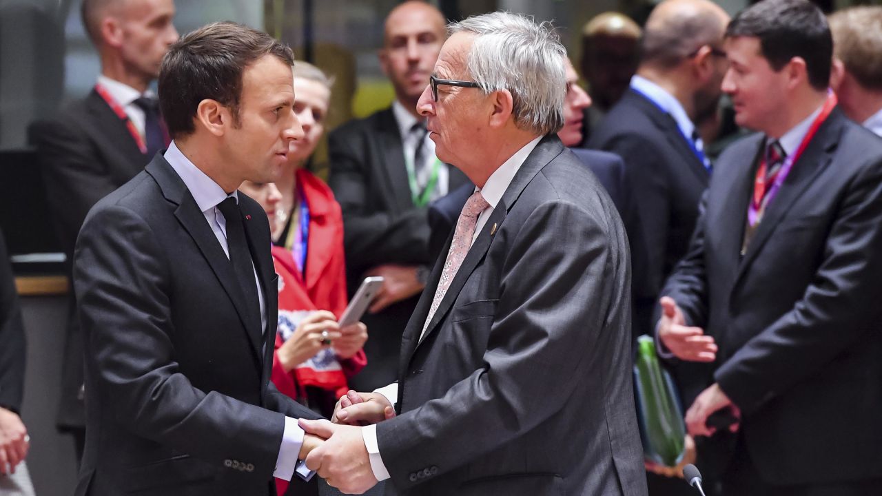 France's Emmanuel Macron speaks with European Commission President Jean-Claude Juncker on Thursday. 