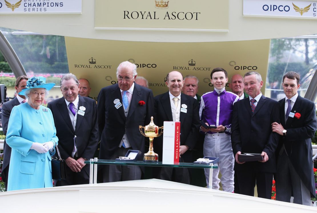 Queen presents the Ascot Gold Cup to winning owners Derek Smith, John Magnier and Michael Tabor in 2014.