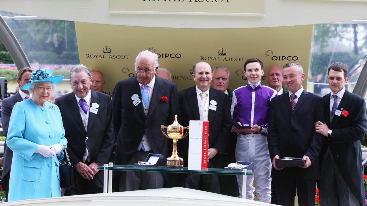 Queen presents the Ascot Gold Cup to winning owners Derek Smith, John Magnier and Michael Tabor in 2014.