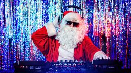 DJ Santa Claus mixing up some Christmas cheer. Disco lights in the background.; Shutterstock ID 121218244; Job: -