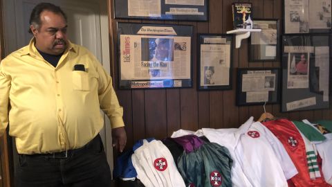 Daryl Davis looks at his collection of KKK robes, given up by Klansmen he has befriended.