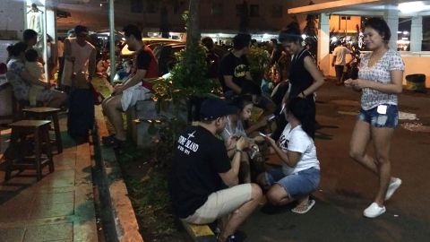 Residents gather outside their apartment blocks in Jakarta after the earthquake.