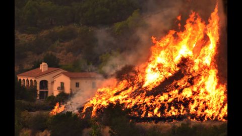 Flames from a back-firing operation rise behind a home off Ladera Lane near Bella Vista Drive in Santa Barbara, California, on Thursday, December 14. Powerful Santa Ana winds and extremely dry conditions are fueling <a href="http://www.cnn.com/2017/12/07/us/ventura-fire-california/index.html" target="_blank">wildfires in Southern California</a> in what has been a devastating year for <a href="http://www.cnn.com/interactive/2017/12/us/california-wildfires-cnnphotos/" target="_blank">such natural disasters in the state.</a>