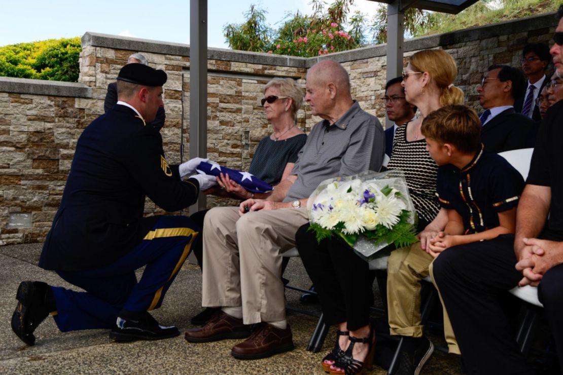 A soldier presents a burial flag to the next of kin of US Army Pfc. Albert E. Atkins on Friday at the National Memorial Cemetery of the Pacific in Honolulu, Hawaii. 