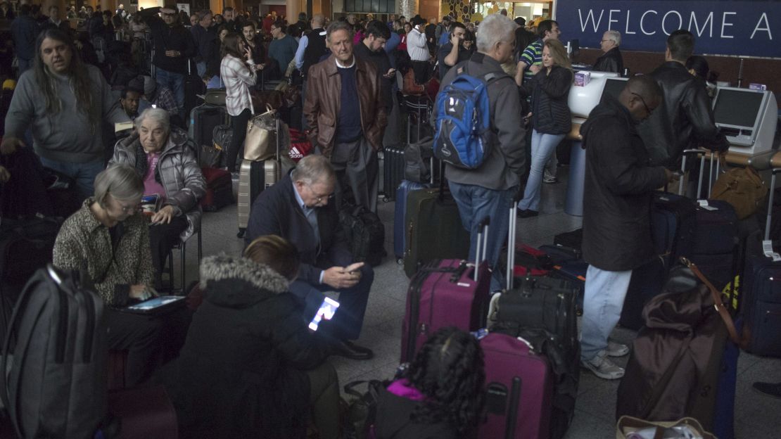 Passengers wait in a dark terminal at the Atlanta airport Sunday. 
