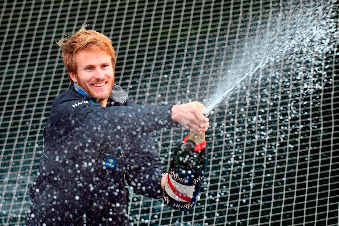 Gabart sprays champagne at the end of his solo around the world navigation