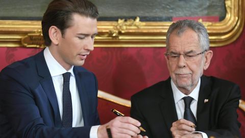 Austrian President Alexander Van der Bellen (R) and Austrian Chancellor of the conservative People's Party Sebastian Kurz sign the letter of appointment during an inauguration ceremony on December 18, 2017.
