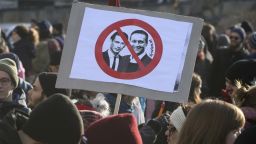 Protestors hold a poster with new Chancellor Sebastian Kern and new Vice Chancellor Heinz-Christian Strache at a demonstration during the swearing-in ceremony of the new Austrian government led by a conservative and a nationalist party in Vienna, Austria, Monday, Dec. 18, 2017. (AP Photo/Ronald Zak)